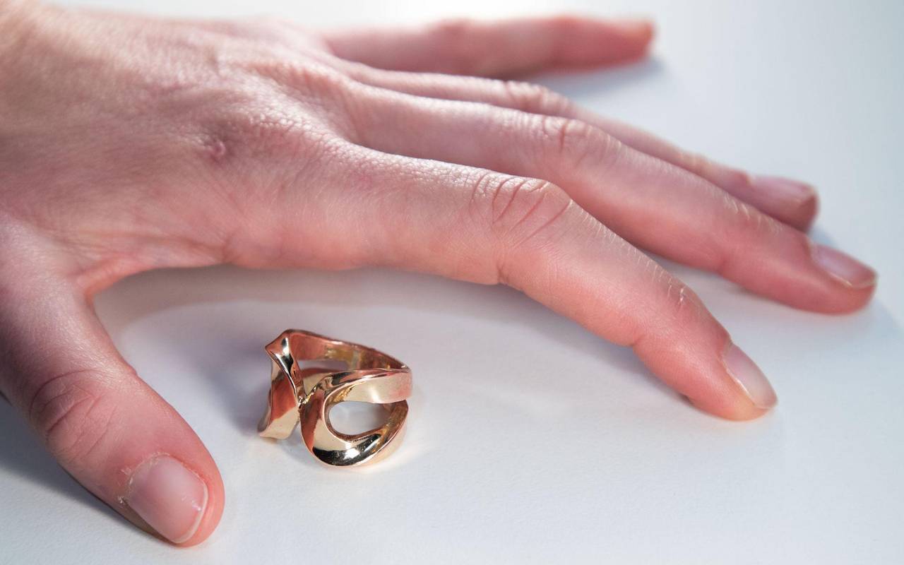 Ein Ring liegt neben der Hand einer Frau